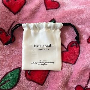 Tiny Kate Spade Cream Drawstring Bag